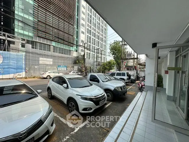 Modern urban building exterior with parking area and city view