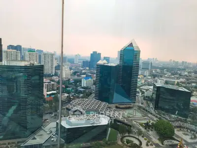 Stunning cityscape view from a high-rise building showcasing modern architecture and urban skyline.