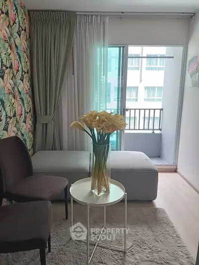 Chic living room with floral accent wall and balcony access in modern apartment