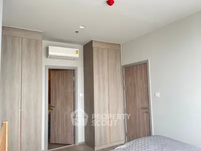 Modern bedroom with built-in wardrobes and air conditioning
