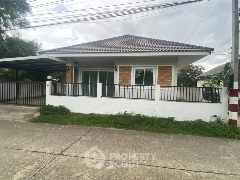 Charming single-story house with modern design and spacious driveway in a serene neighborhood.
