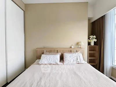 Spacious bedroom with elegant decor and natural light