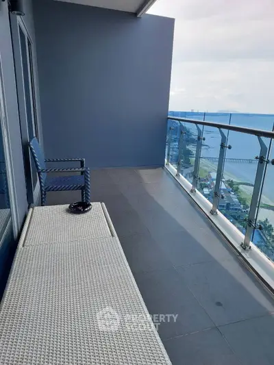 Spacious balcony with stunning sea view and modern glass railing