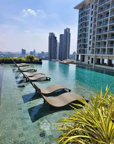 Luxurious rooftop pool with stunning city skyline views and modern high-rise building.