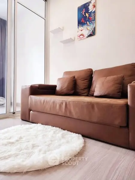 Cozy living room with brown leather sofa and fluffy white rug