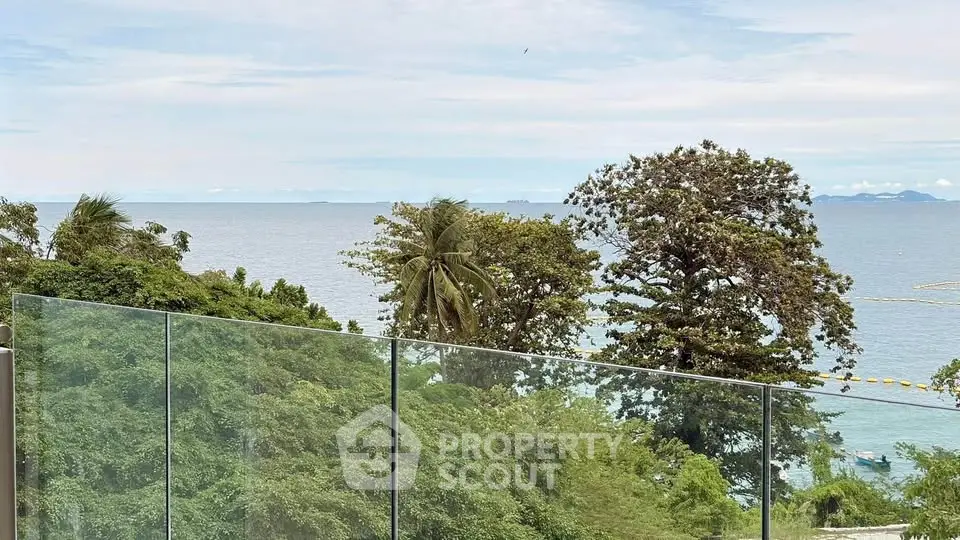 Stunning ocean view from a modern glass balcony, perfect for relaxation.