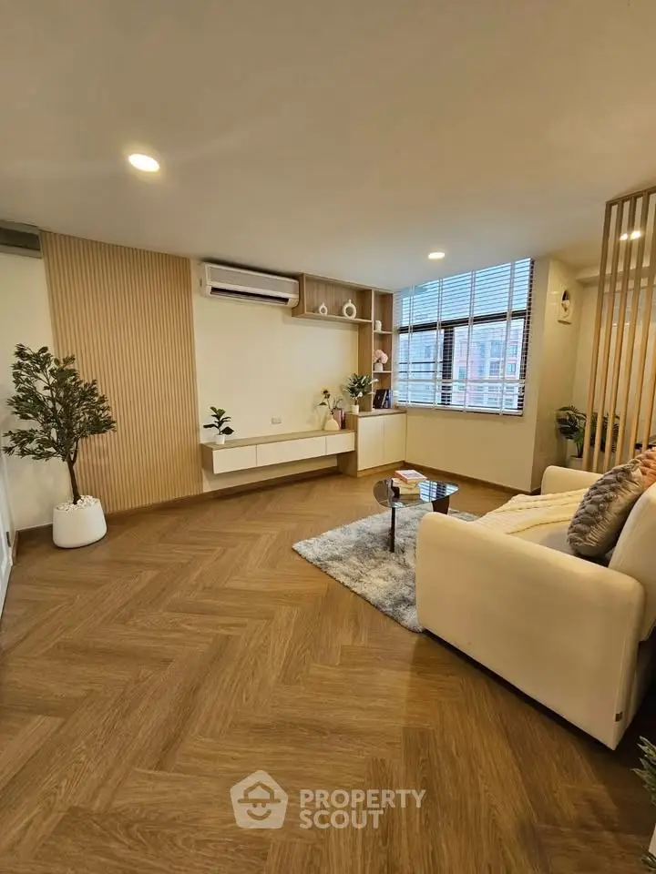 Modern living room with stylish decor and large windows for natural light.