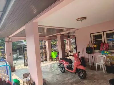 Charming covered patio with scooter, ideal for relaxation and outdoor activities in a cozy residential setting.