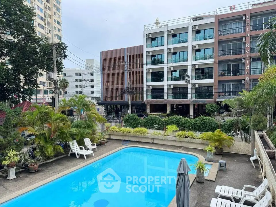 Charming residential building with inviting pool and lush greenery in urban setting.