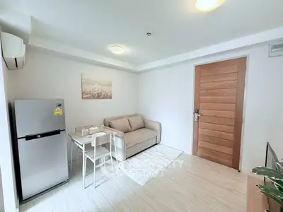 Cozy living room with modern decor and compact dining area