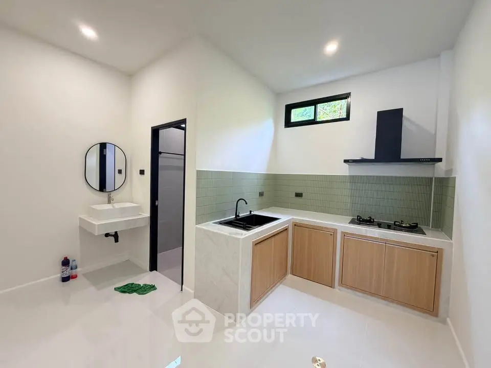 Modern kitchen with sleek design, featuring gas stove and stylish cabinetry, perfect for culinary enthusiasts.