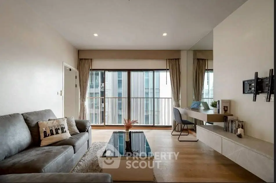 Modern living room with sleek furniture and large windows in a stylish apartment.