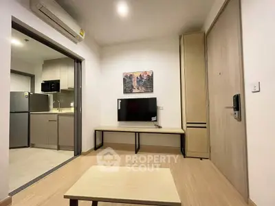 Modern living room with open kitchen and stylish decor in a cozy apartment.