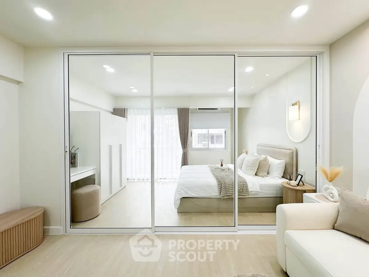 Modern bedroom with glass sliding doors and elegant decor