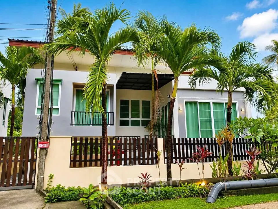 Charming tropical-style house with lush garden and modern design, perfect for serene living.