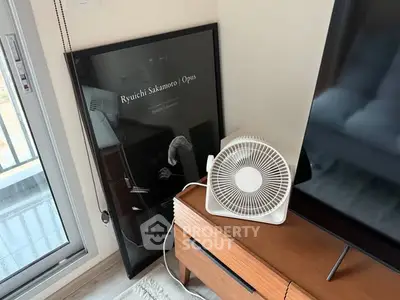 Stylish interior with modern fan and elegant decor near balcony.