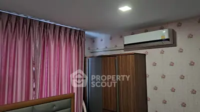 Cozy bedroom with pink curtains and air conditioning unit
