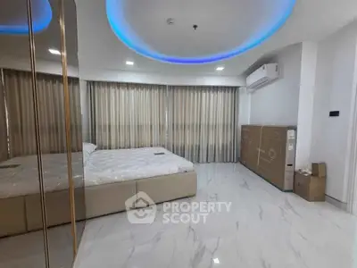 Luxurious bedroom with modern design, featuring marble flooring and ambient lighting.