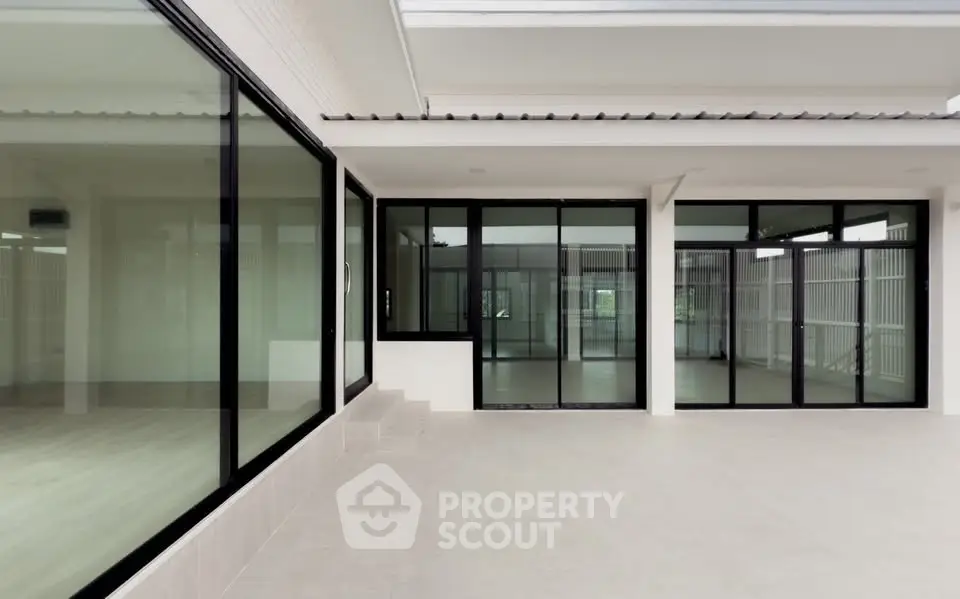 Spacious modern building exterior with large glass windows and sleek design.