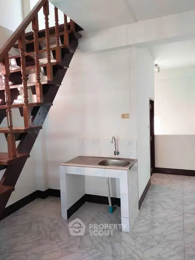 Charming small kitchen area with staircase in modern home