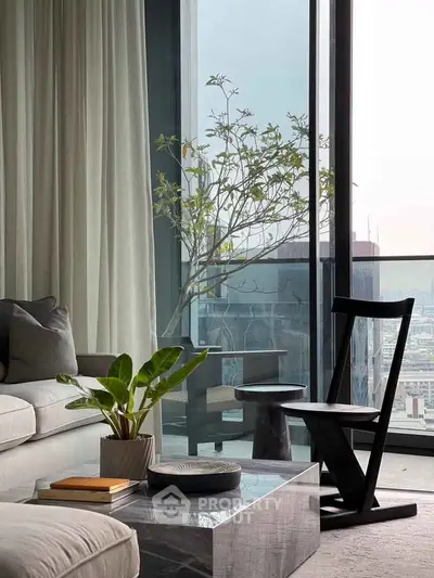 Modern living room with floor-to-ceiling windows and city view, featuring stylish furniture and decor.