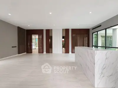 Spacious modern living room with marble accents and large windows