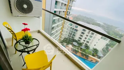 Charming balcony with vibrant yellow chairs and stunning city view, perfect for relaxation.