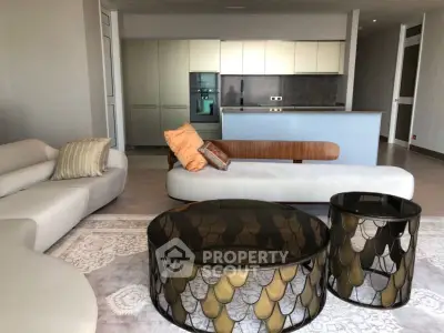 Luxurious modern living room with stylish furniture and open kitchen layout, perfect for contemporary living.