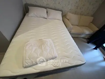 Cozy bedroom with a comfortable bed and elegant sofa, perfect for relaxation.