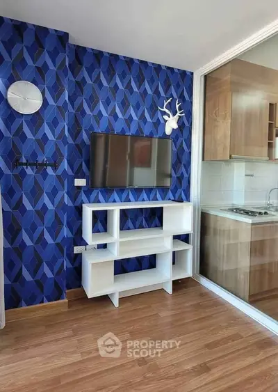 Modern living room with stylish blue geometric wallpaper and sleek TV stand