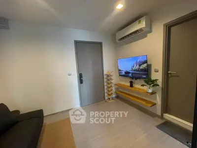 Modern living room with air conditioning and wall-mounted TV