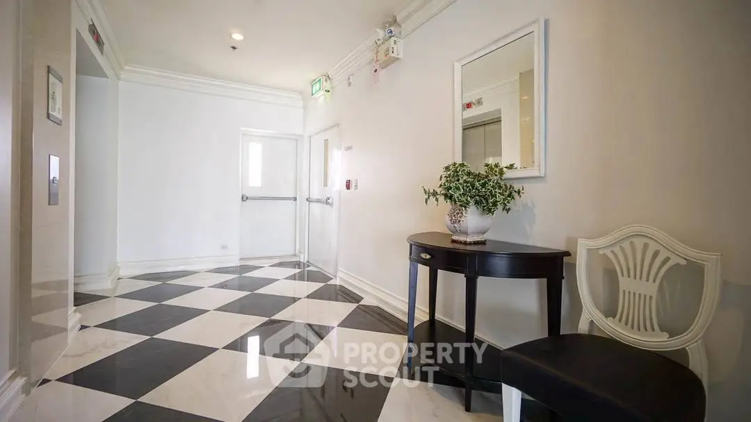 Elegant building entrance with checkered floor and stylish decor