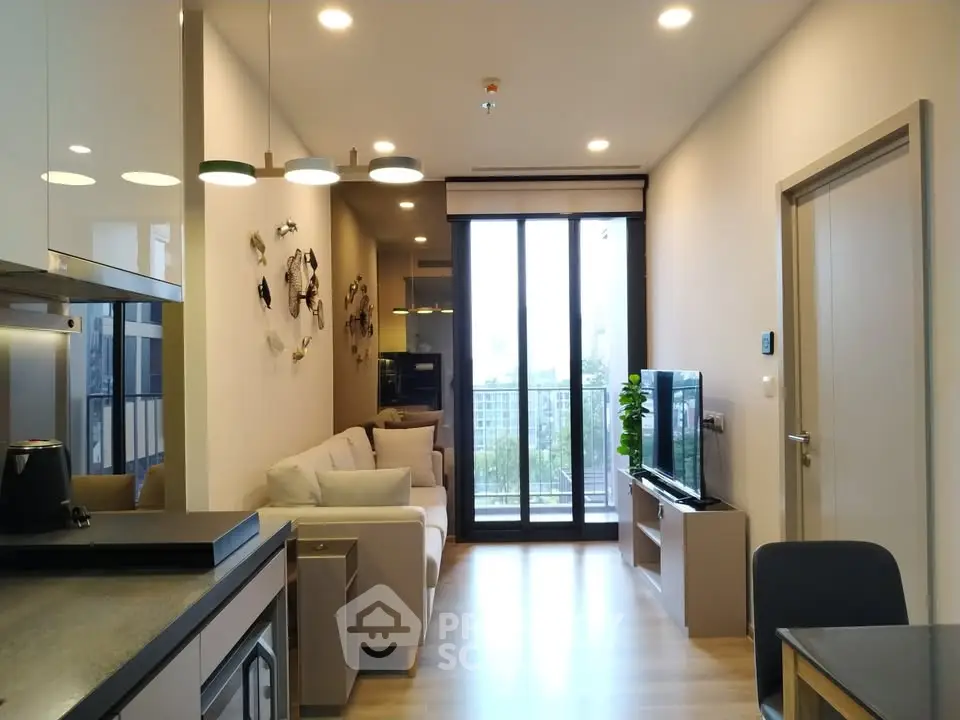 Modern living room with stylish decor and large windows offering natural light.