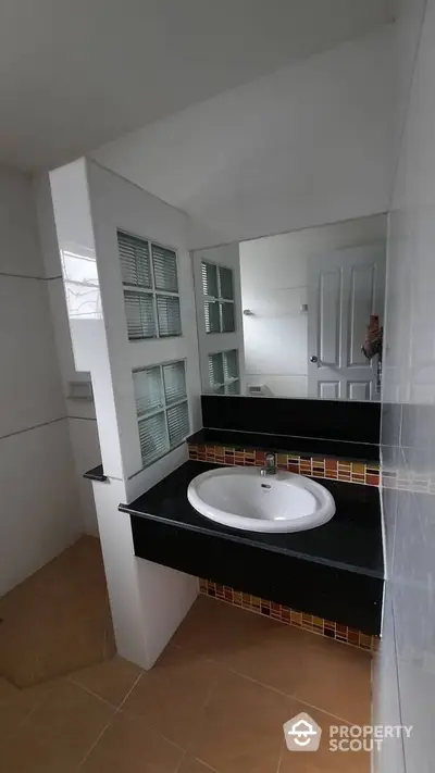 Modern bathroom with stylish sink and large mirror