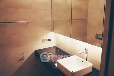 Modern bathroom with sleek sink and large mirror, ideal for contemporary living.