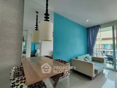 Modern living room with vibrant blue accent wall and stylish furniture