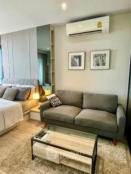 Modern living room with cozy gray sofa and stylish decor in a contemporary apartment.