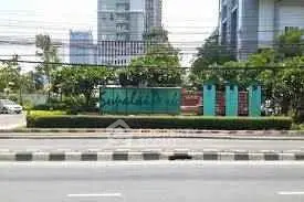 Prime real estate location with lush greenery and modern architecture in urban setting.
