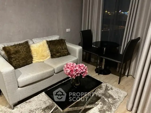Stylish living room with cozy sofa, elegant decor, and city view