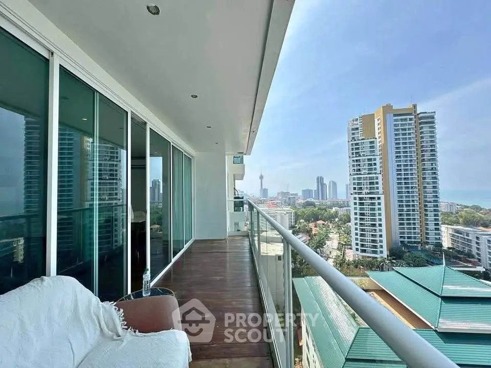 Spacious balcony with stunning cityscape view in modern high-rise apartment