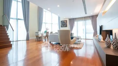 Spacious modern living room with high ceilings and elegant decor in luxury apartment.