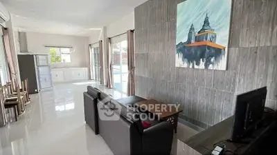 Spacious modern living room with sleek furniture and natural light, perfect for relaxation and entertainment.