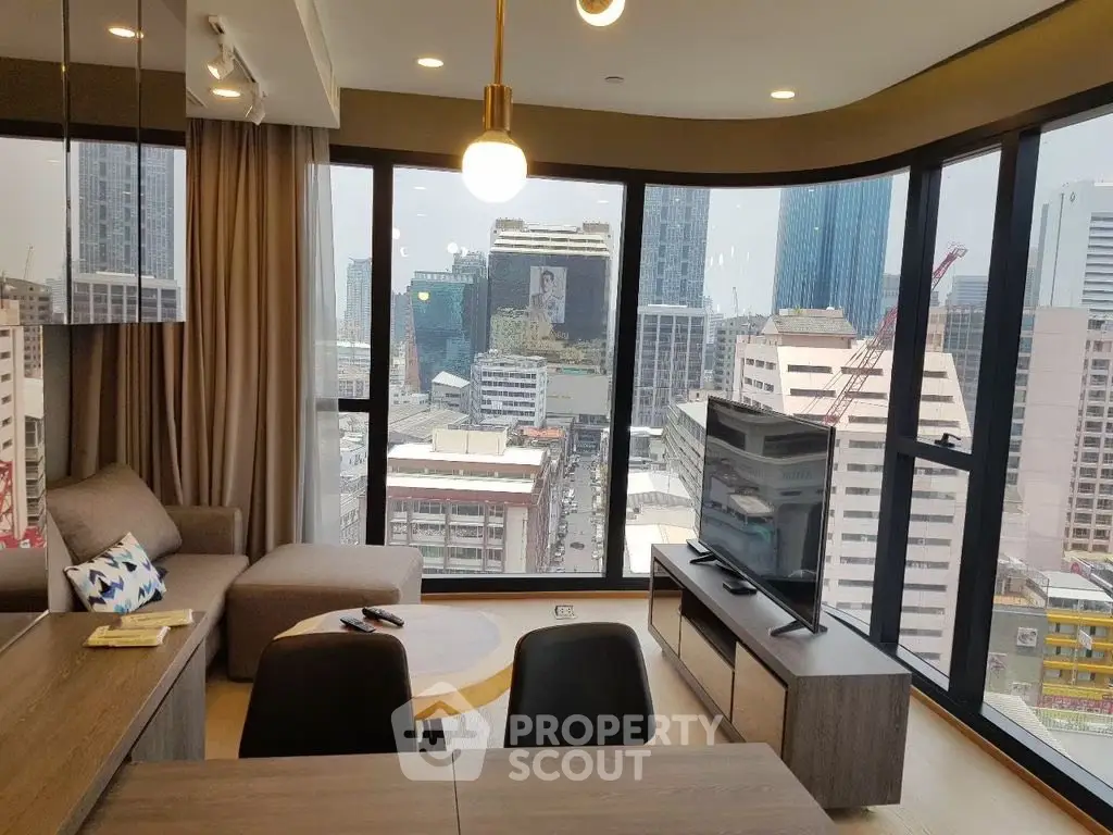Modern living room with panoramic city view and stylish furniture in high-rise apartment.