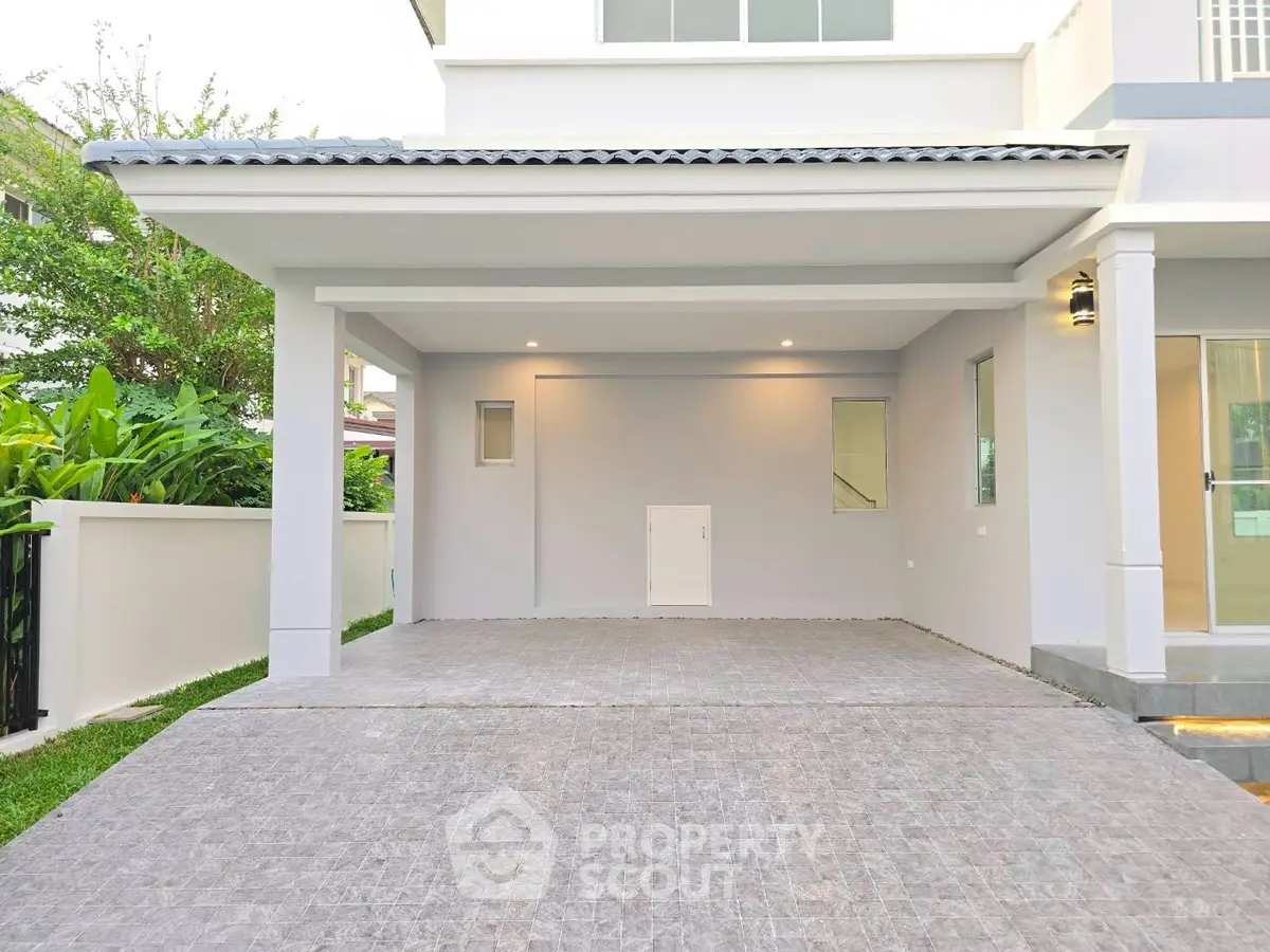 Modern house exterior with spacious driveway and sleek design