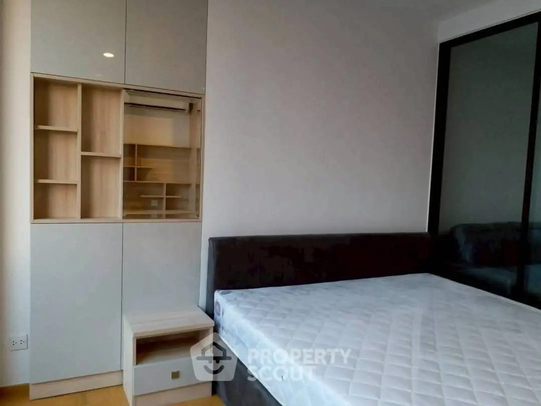 Modern bedroom with sleek built-in storage and comfortable bed