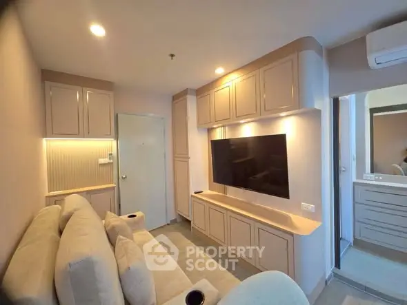 Modern living room with built-in cabinets and wall-mounted TV