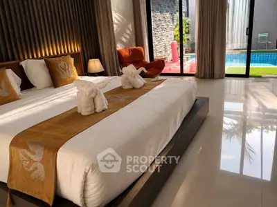 Luxurious bedroom with pool view and elegant decor