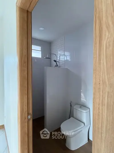 Modern bathroom with sleek shower and wooden accents