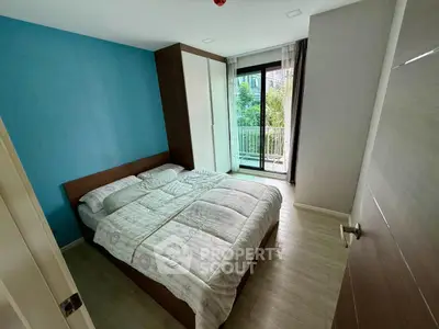 Cozy bedroom with balcony access and modern decor in a stylish apartment.