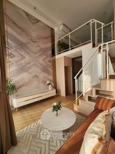 Luxurious modern living room with high ceiling and mezzanine, featuring elegant decor and natural light.